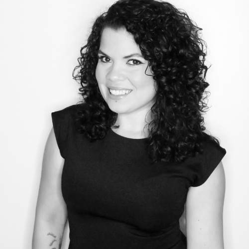 Black and white image of woman with dark hair smiling at camera