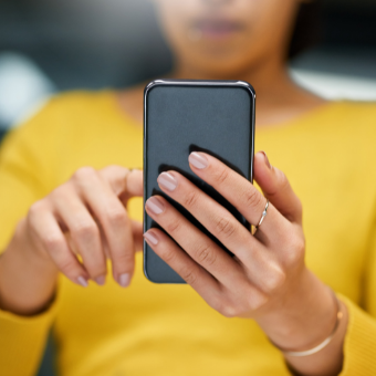 woman looks at iphone
